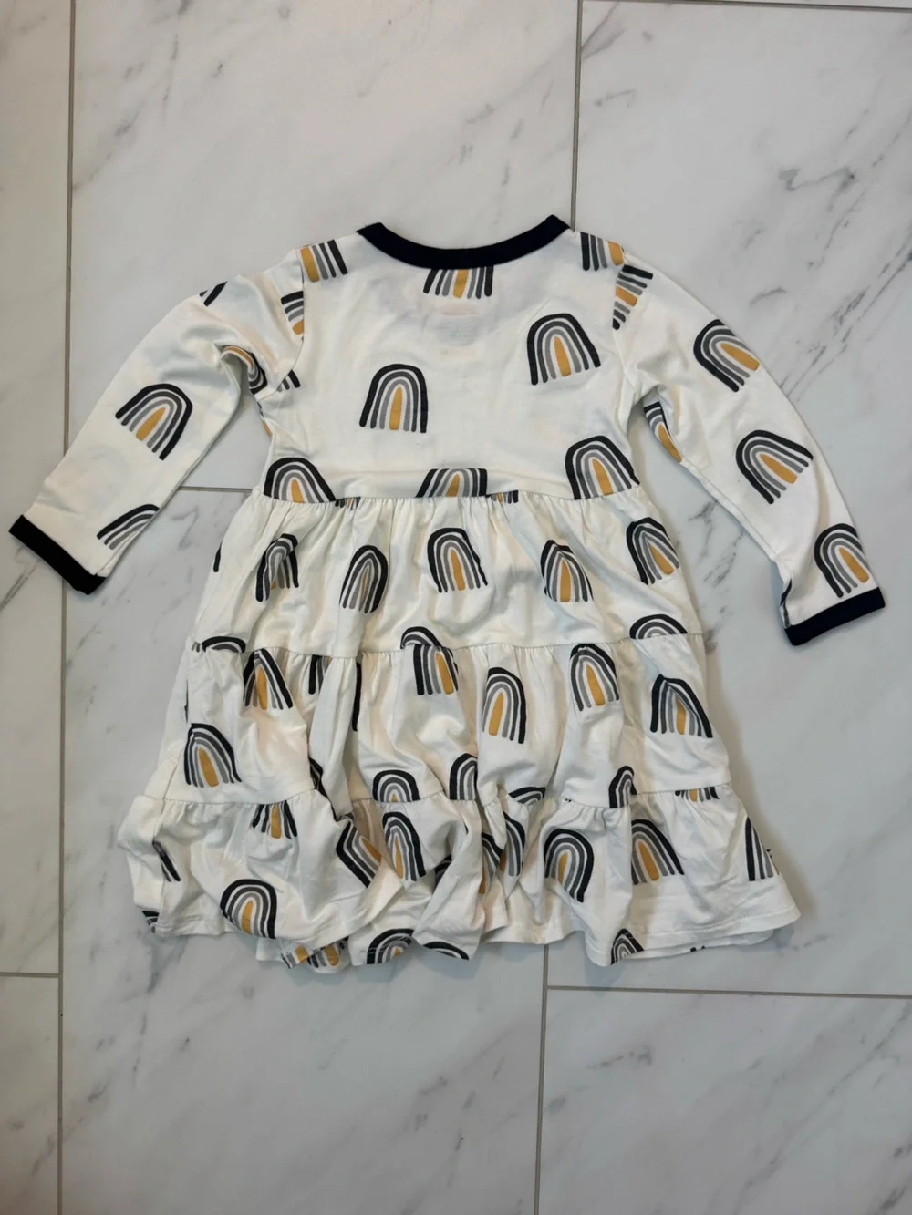 Kyte BABY White Dress with Black Trim and Mustard Rainbow Print
